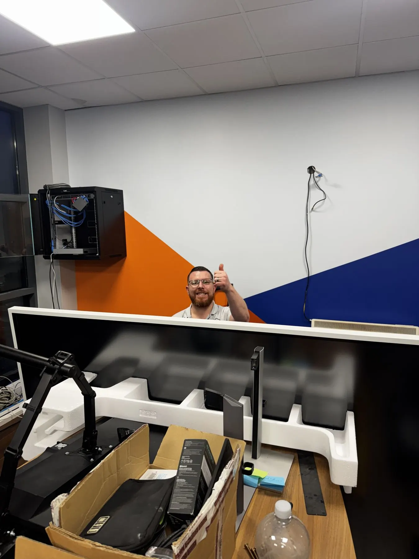 Commercial AV equipment mounted neatly on a wall for meeting room control.