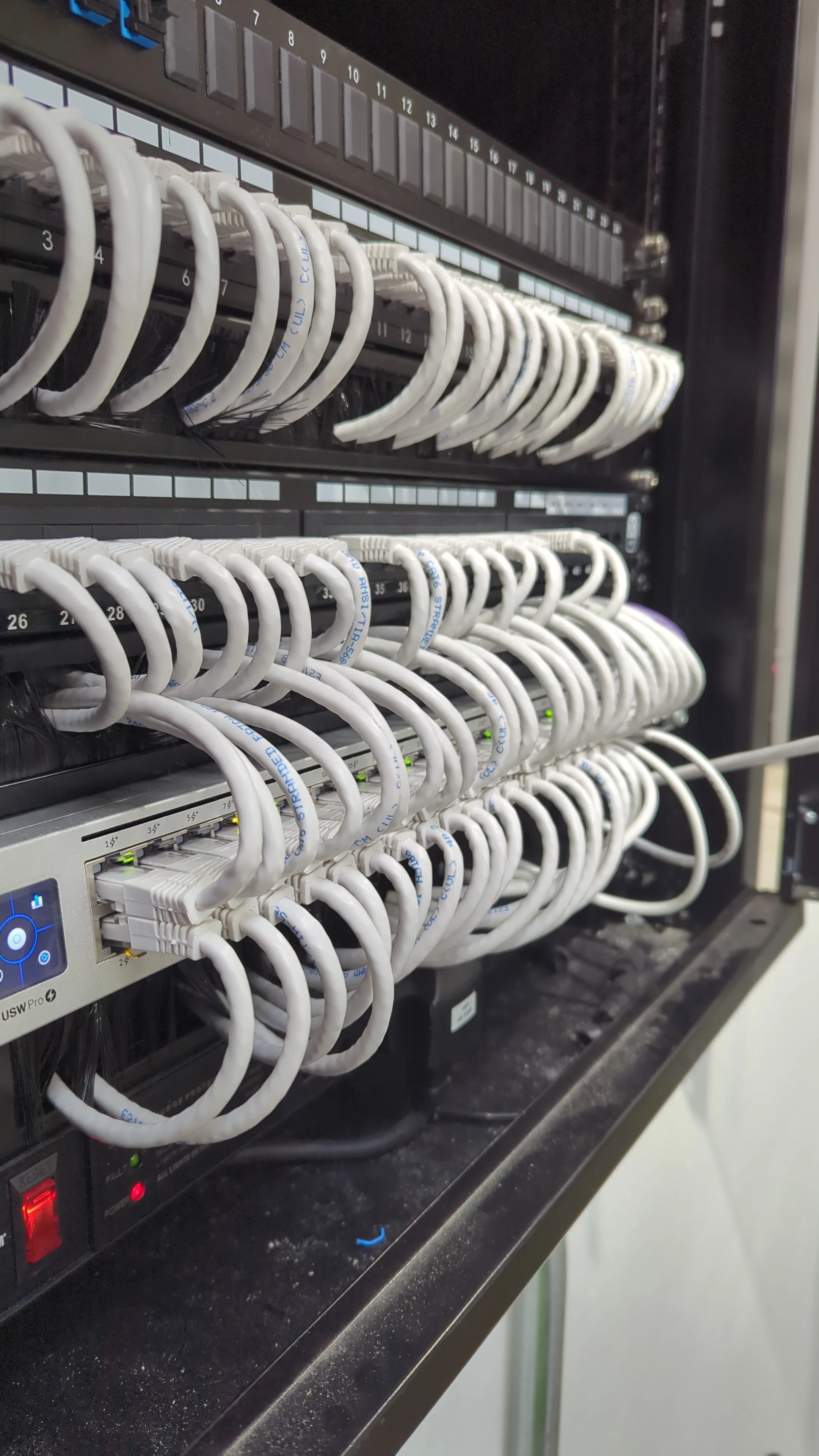 Commercial network rack with dressed and labelled structured cabling installed by True Tech Solutions