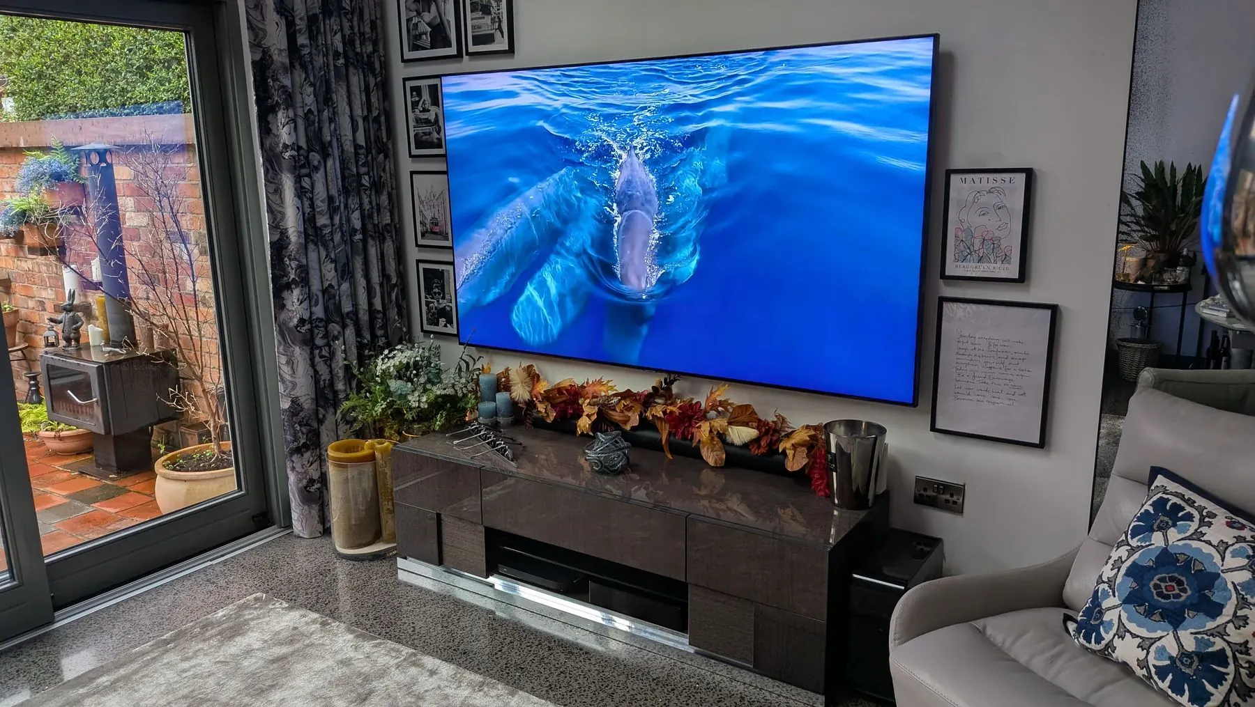 Large living room TV wall mounting installation with a clean audio visual finish.