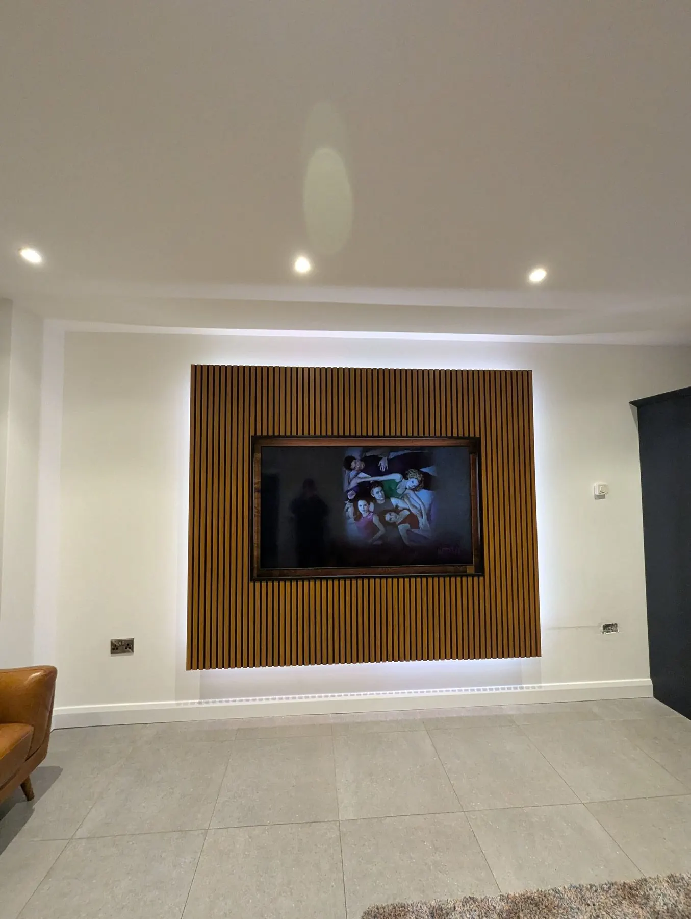 Bespoke media wall with hidden cabling and LED feature lighting installed by True Tech Solutions Belfast