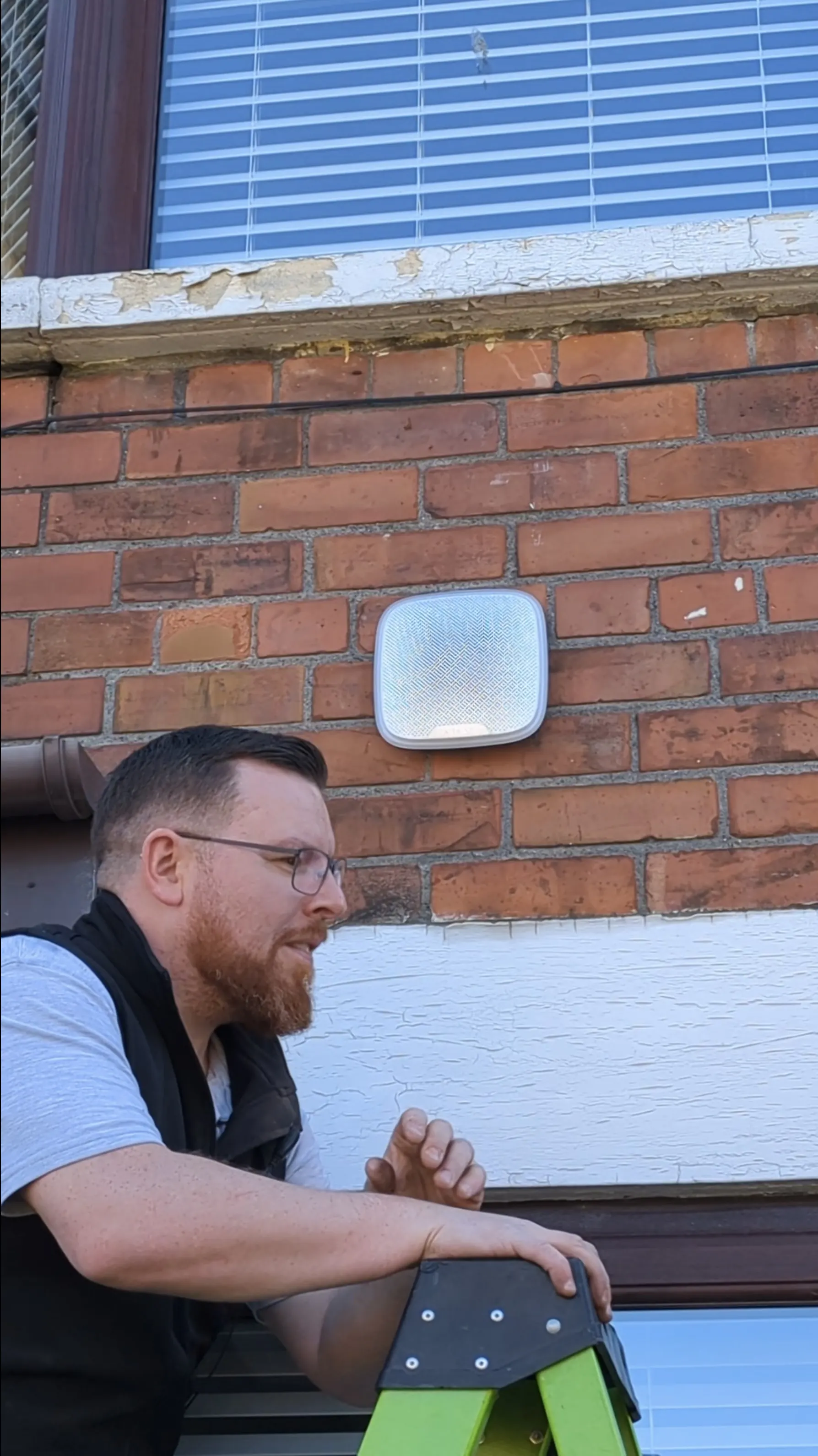 Ajax external home alarm siren installed above a window for residential security in Belfast.