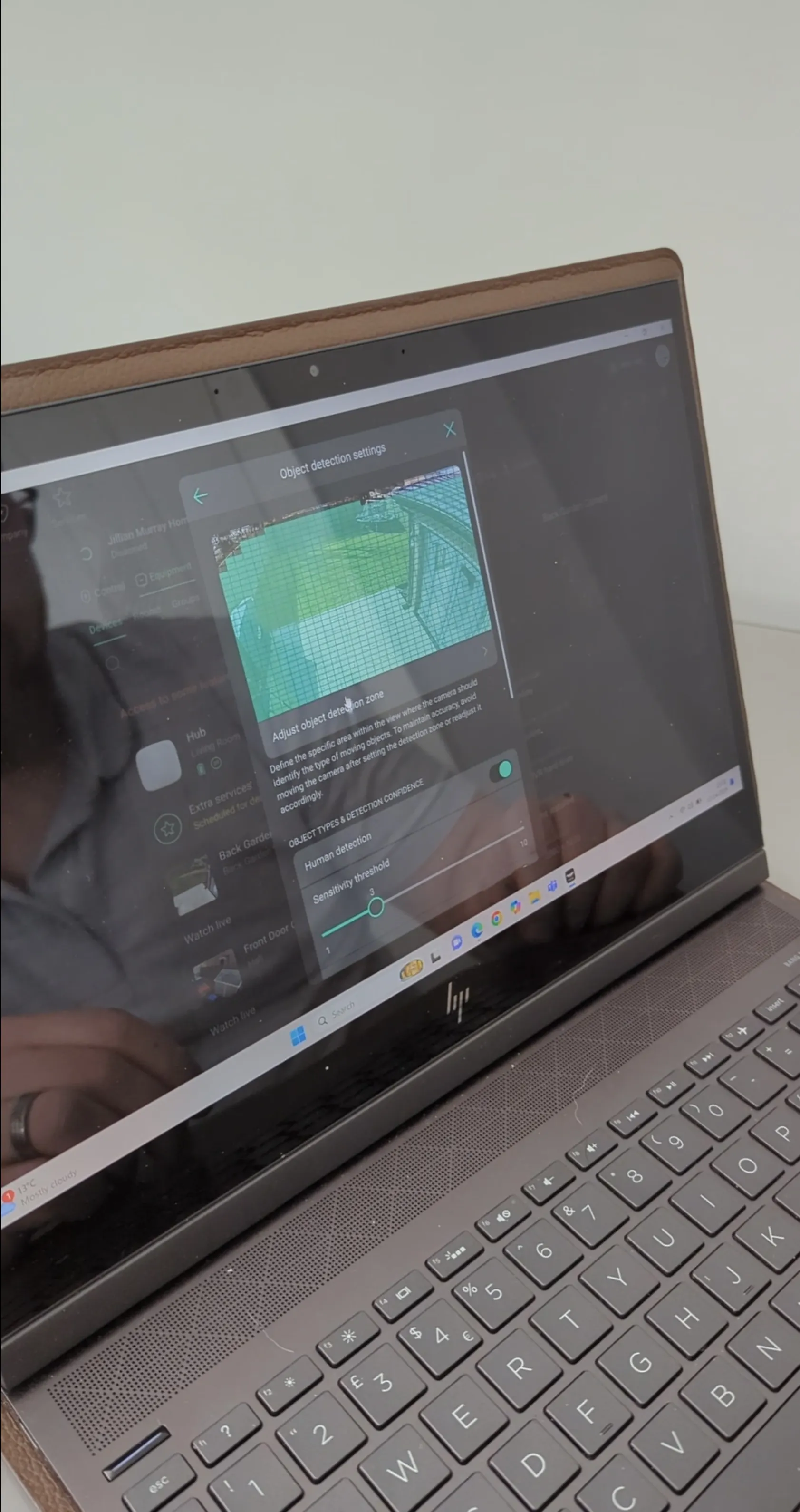 Ajax alarm and camera detection settings configured on a laptop for residential security.