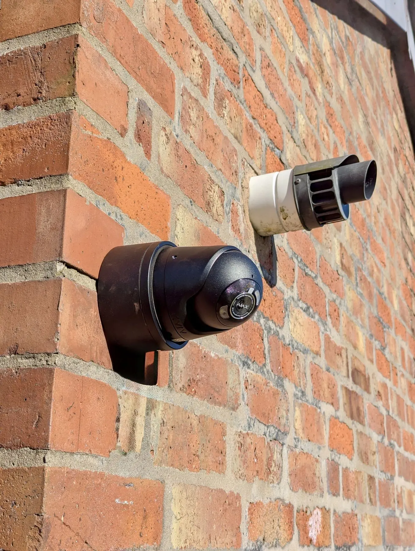 Two Hikvision external CCTV cameras mounted on a home for wider security coverage.