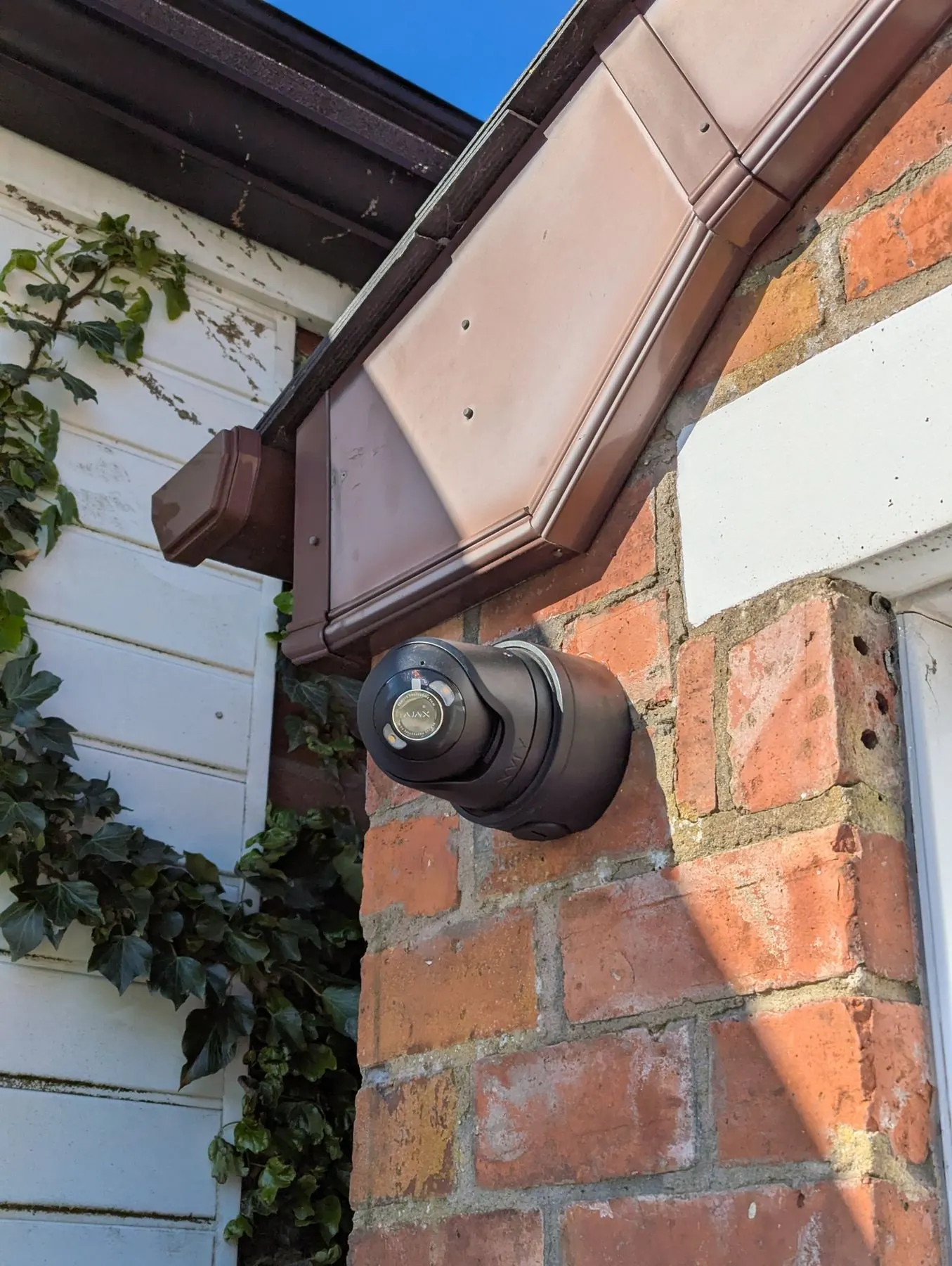Hikvision home CCTV camera fitted neatly under house eaves in Northern Ireland.