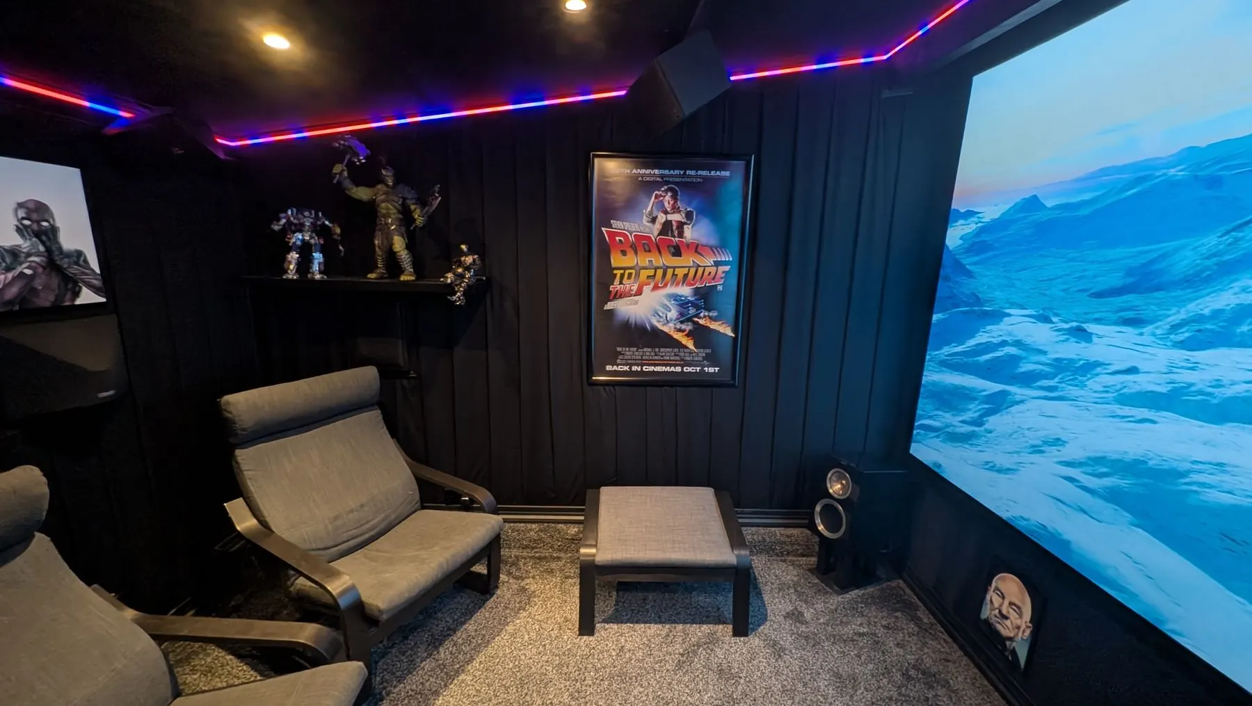 Private home cinema room with LED feature lighting and AV setup.