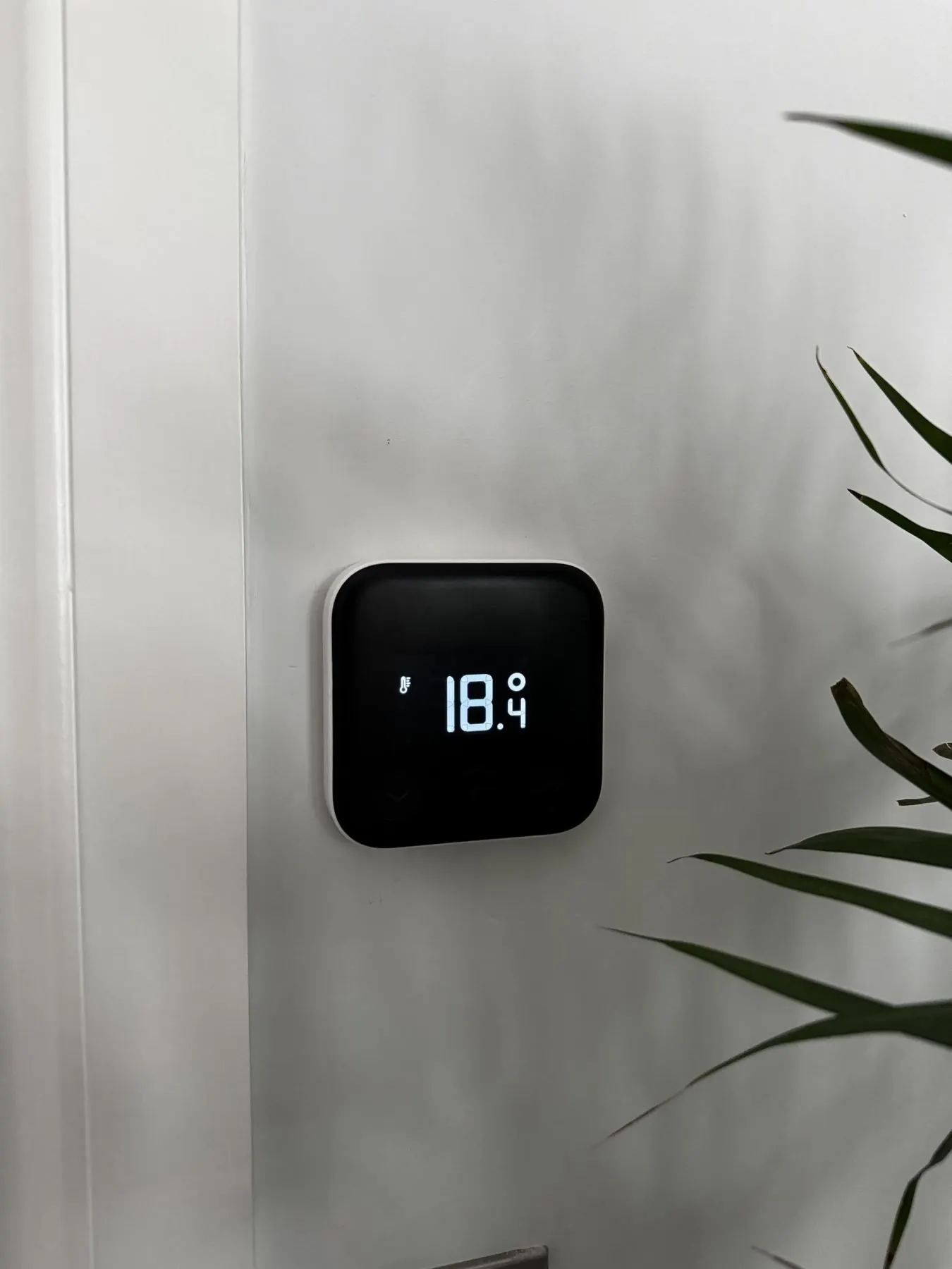 Tado smart thermostat fitted to a wall for residential smart heating control.