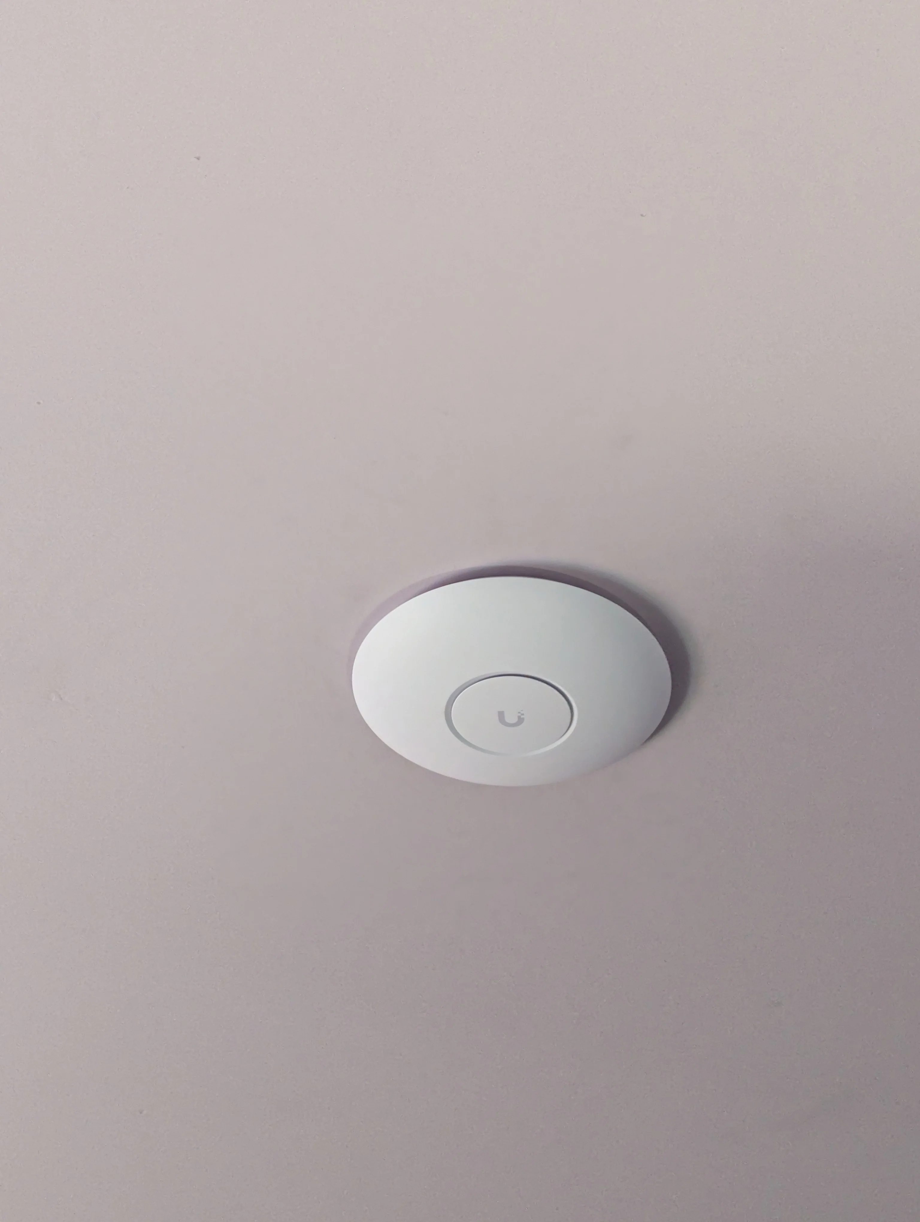 Close up of a TP-Link Omada ceiling Wi-Fi access point for residential coverage.