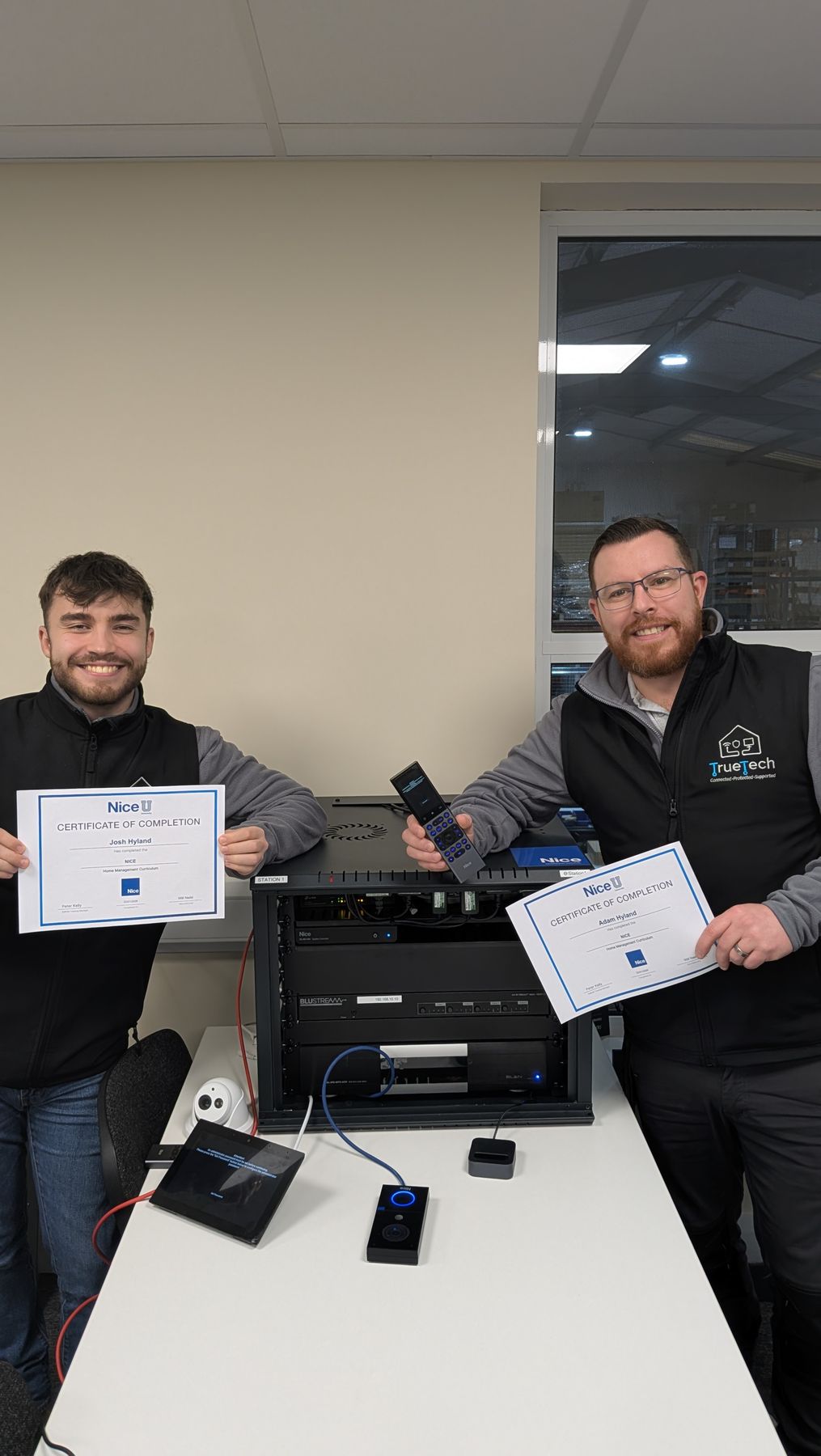 Adam and Josh Hyland of True Tech Solutions with their NICE home management training certificates